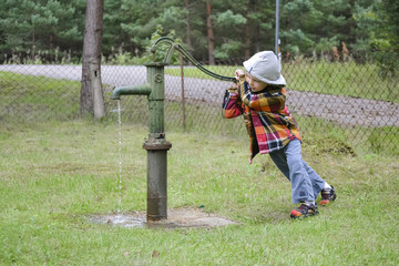 Boy and water pump