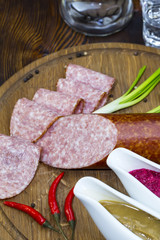 sausages on a wooden plate with vegetables in a restaurant