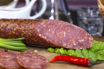 sausages on a wooden plate with vegetables in a restaurant