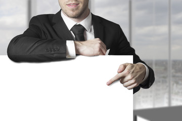 businessman leaning pointing on blank sign