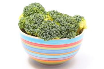 Fresh green broccoli in colorful bowl white background