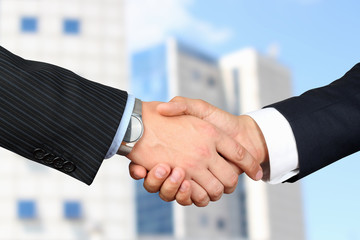 Close-up image of a firm handshake  between two colleagues outsi