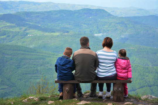 Family on a mountain lookout observing nature