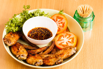 Grilled chicken wings on dish.