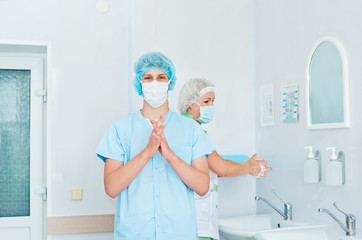 Medical staff sterilizing hands and arms before surgery