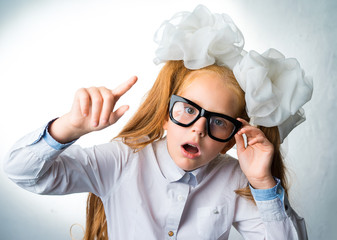 Emotional portrait of schoolgirl with glasses