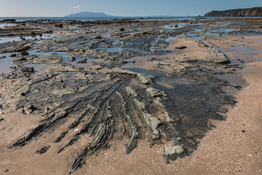volcanic rock formations on beach at Omaha Bay, New Zealand