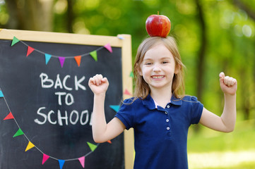 Extremely excited little schoolgirl