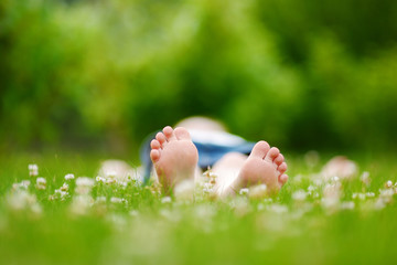 Childrens feet on grass outdoors