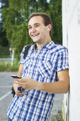 Smiling young man listening to music outdoor