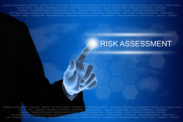 business hand clicking risk assessment button on touch screen