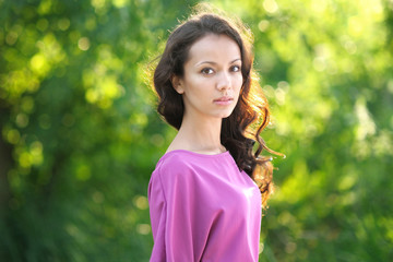 Fototapeta premium beautiful elegant brunette girl in a field