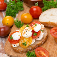 toast with mozzarella and colorful cherry tomatoes