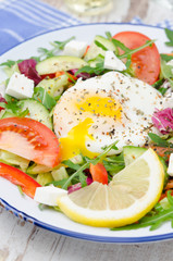 Vegetable salad with poached egg, vertical, closeup