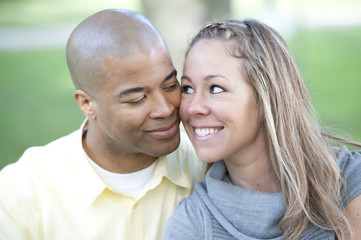 Fototapeta premium Happy young interracial couple posing together on a sunny day.