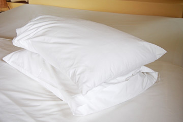Fototapeta na wymiar white pillows on bed in bedroom