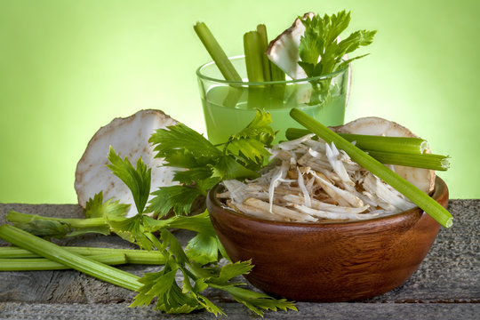 .Celery salad with celery juice on a wooden table