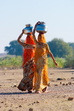 Women carrying water in Rajasthan, India