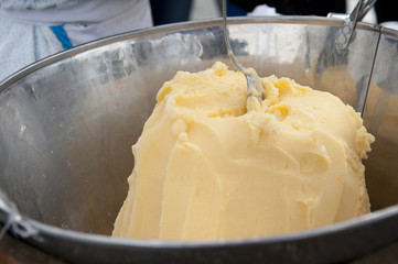 Hand made ice cream made with a spoon in it on a sunny day.