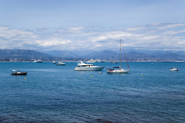 Fototapeta na wymiar Antibes, France. Yacht on a background of mountains
