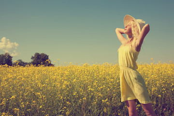 Fototapeta premium Beautiful young girl in the summer field.