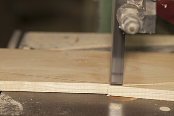 Bandsaw cutting wood plank