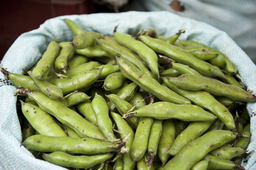 A sack of green peas at a farmers market.
