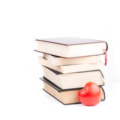 Books with heart on white isolated background