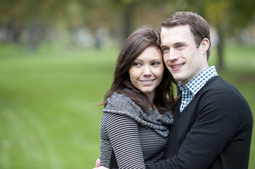 Fototapeta premium A young and happy couple looking to the left with room for copy space.