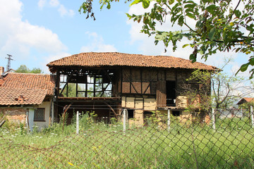 Fototapeta na wymiar Rural scene with abandoned house in Bulgarian countryside