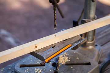 Old electric drill press with drill bits for wood
