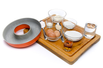 Ingredients to prepare a French ring cake, named savarin