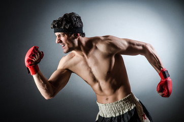 Muscular boxer wiith red gloves