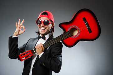 Funny guitar player in studio