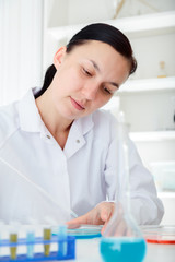 laboratory assistant analyzing a sample