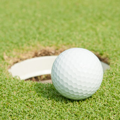 golf ball on lip of cup