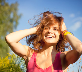 portrait of young beautiful happy woman with flying hair