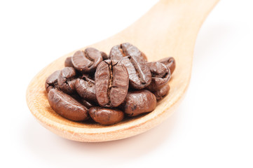 Wooden spoon with coffee beans  isolated on white background.
