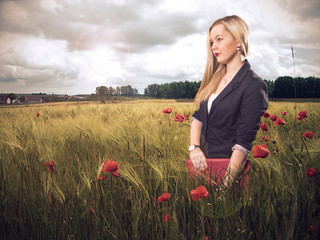 Woman in poppy field smiling
