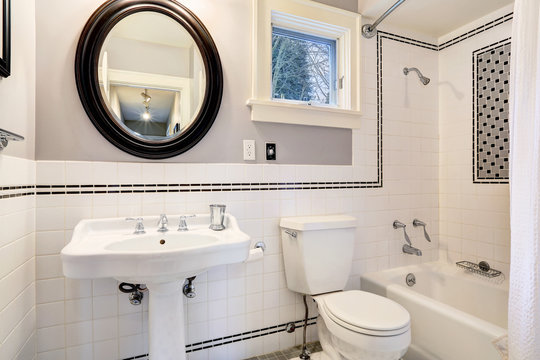 White bathroom with tile wall trim