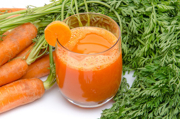 Composition with a glass of carrot juice and carrots