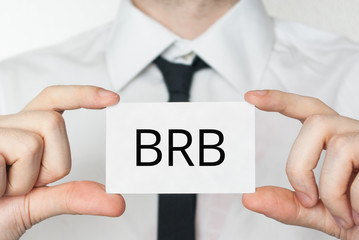 BRB. Businessman holding business card