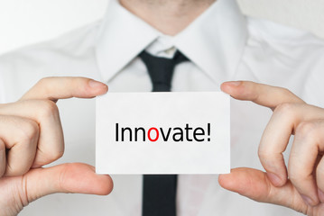 Innovate. Businessman holding business card