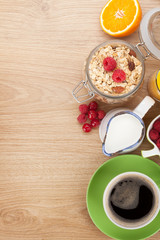 Healty breakfast with muesli, berries, orange juice, coffee and