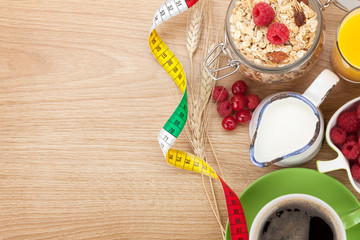 Healty breakfast with muesli, berries, orange juice, coffee and
