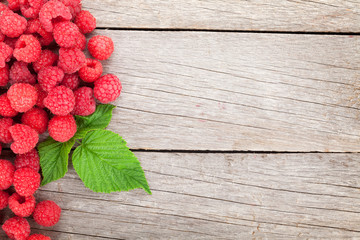 Fresh ripe raspberries on wooden table