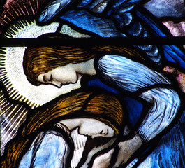 Two grieving angels in stained glass