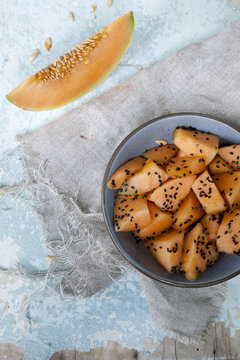 snack with pieces and slice of melon and sesame seed on bowl
