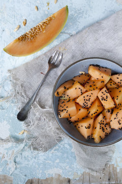 snack with pieces and slice of melon and sesame seed on bowl