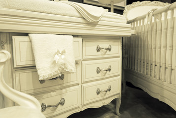 White chest of drawers with a towel